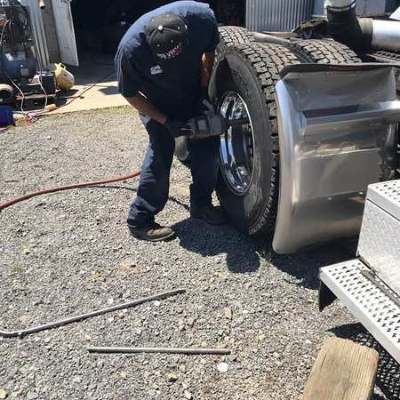 Technician servicing commercial truck tire
